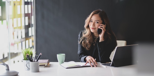 Attractive Asian businesswoman smiling and looking 