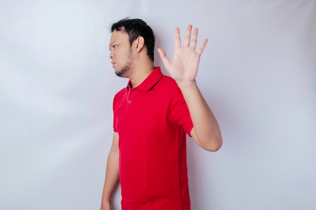 Attractive Asian man with hand gesture pose rejection or prohibition with copy space