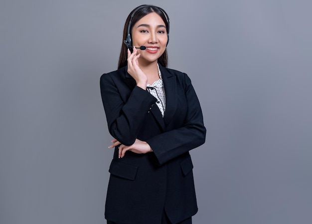 Attractive Asian operator with formal suit and headset Jubilant