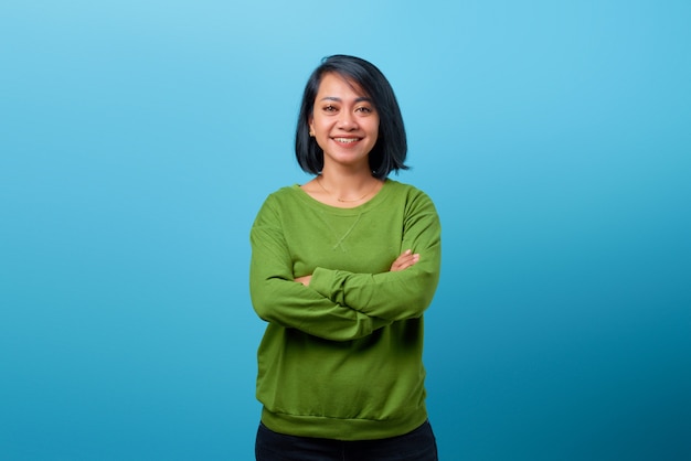 Attractive Asian woman wearing casual clothes smile with crossed arms looking at camera