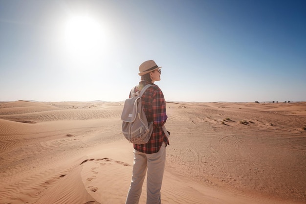 Attractive asian young woman in plaid shirt in desert