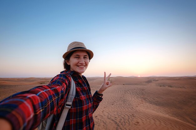 Attractive asian young woman in plaid shirt in desert