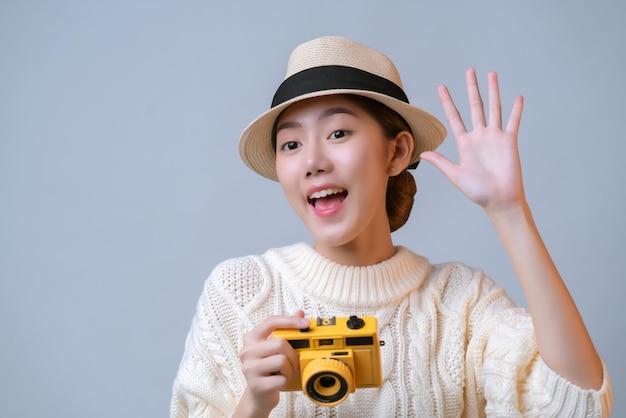 Attractive beautiful asian female casual dress wear hat hand hold film camera travel vacation concept white background