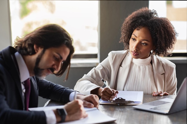 Attractive black lady secretary taking instructions from boss