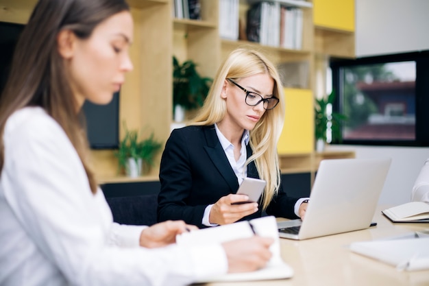 attractive blond businesswomen working in modern office