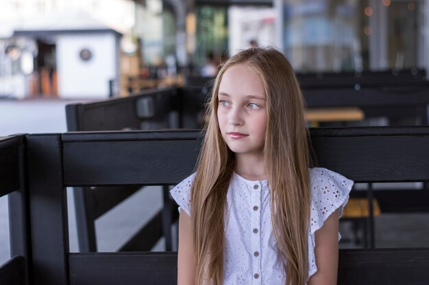 Attractive blond model sitting alone at cafe