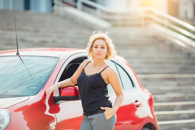 Attractive blonde in a car showing keys