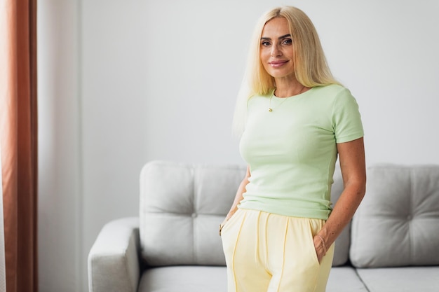 Attractive blonde middle-aged woman in living room at home