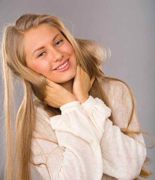 Attractive blonde smiling woman portrait on white background