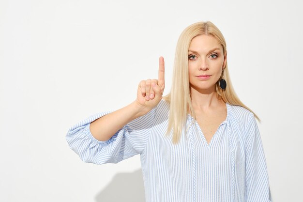 Attractive blonde woman shows one finger Counting with fingers