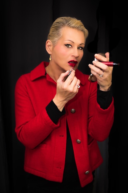 Attractive blonde woman wearing a red coat