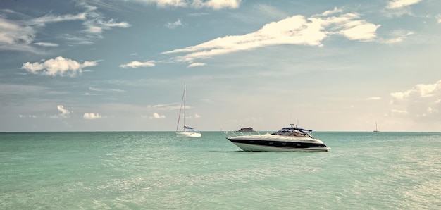 Attractive bright view of exotic colorful beautiful marine beach with boat on blue water