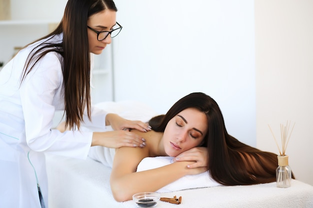 Attractive brunette relaxing with her eyes closed and enjoying spa treatments