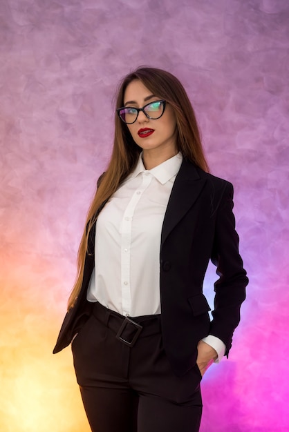 Attractive business woman gesturing ob abstract wall in original spectacles