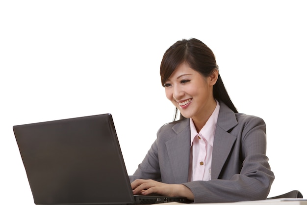 Attractive business woman sitting and smiling at you, closeup portrait.