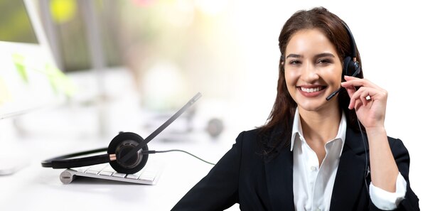 Photo attractive business woman in suits and headsets are smiling while working. customer service