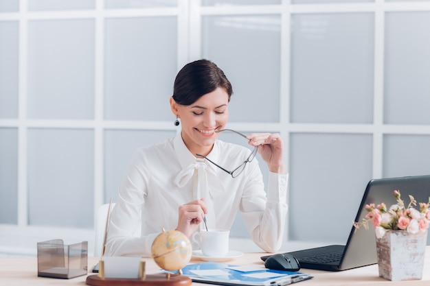 Attractive business woman working at the desk in the office