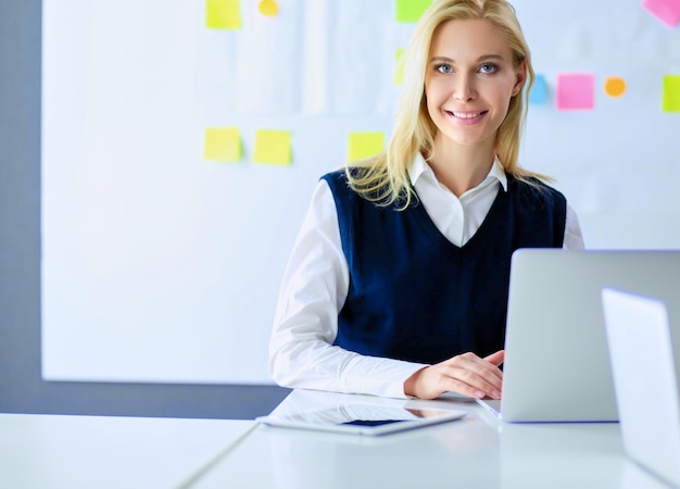 Attractive business woman working on laptop at office Business people