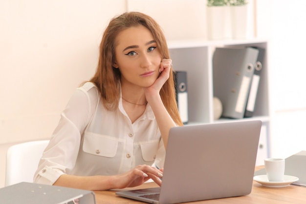 Attractive business woman working at table in office