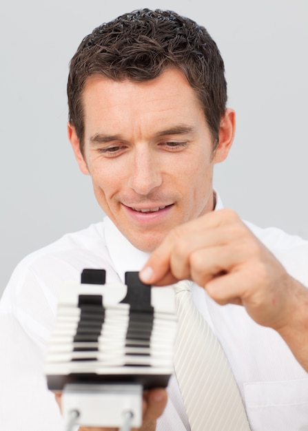 Attractive businessman consulting a card holder