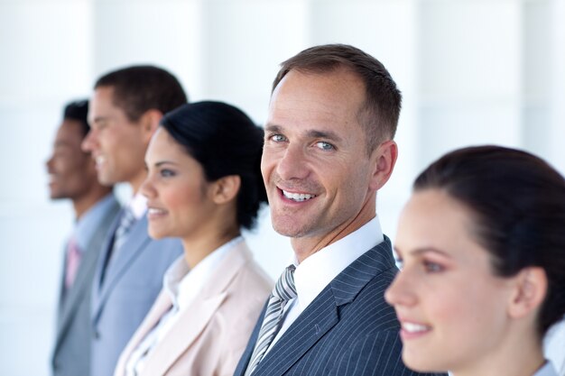 Attractive businessman in a row with his team