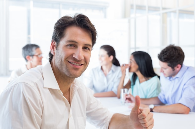 Attractive businessman smiling in the workplace