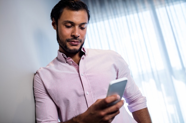 Attractive businessman using smartphone