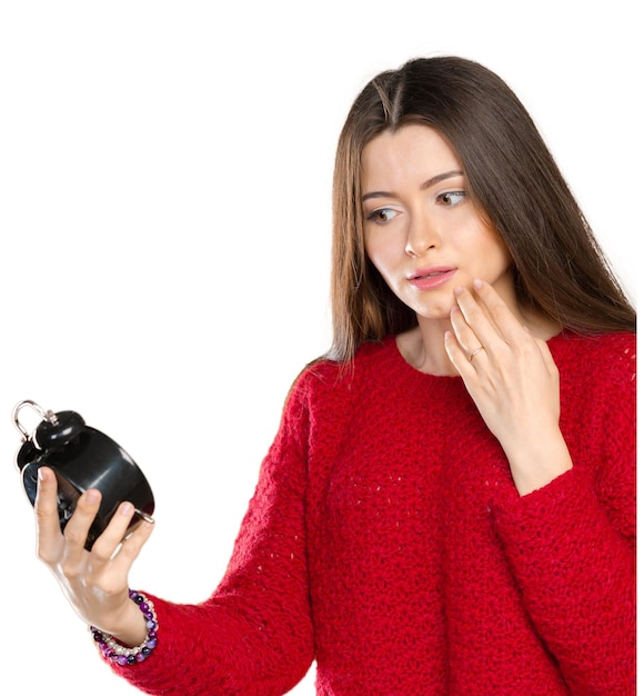 Attractive businesswoman holding alarm clock