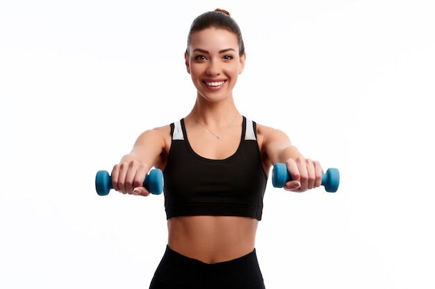 Attractive caucasian slim woman doing physical exercise using dumbbell isolated on white background