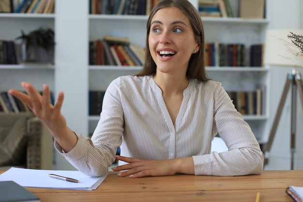 Attractive cheerful business woman working in office.