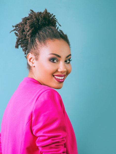 attractive cheerful smiling young woman mixed rase in pink blazer