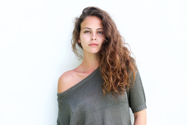 Attractive confident woman standing against white background