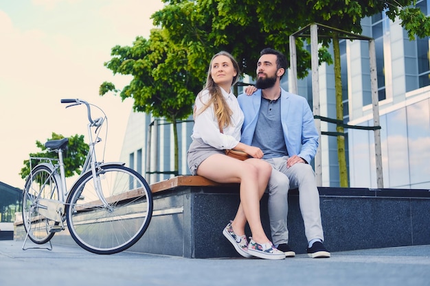 Attractive couple on a date after bicycle ride in a city.