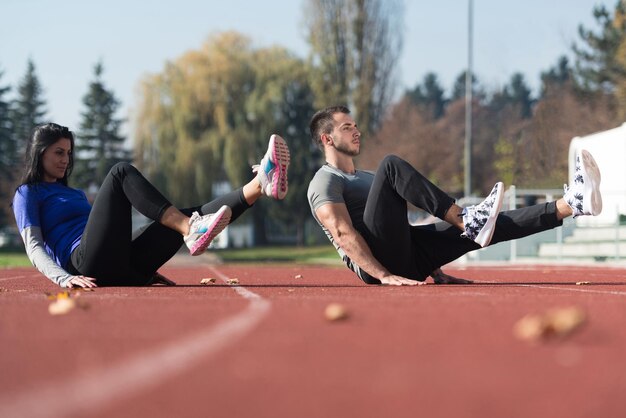 Attractive Couple Exercising in City Park Area  Training and Exercising for Endurance  Fitness Healthy Lifestyle Concept Outdoor