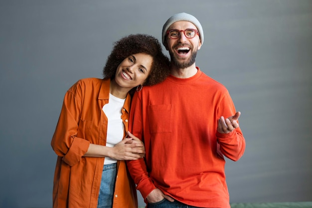 Attractive couple of friends embracing together Portrait of young smiling business colleagues