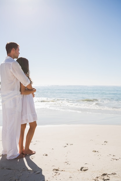 Attractive couple looking out at ocean