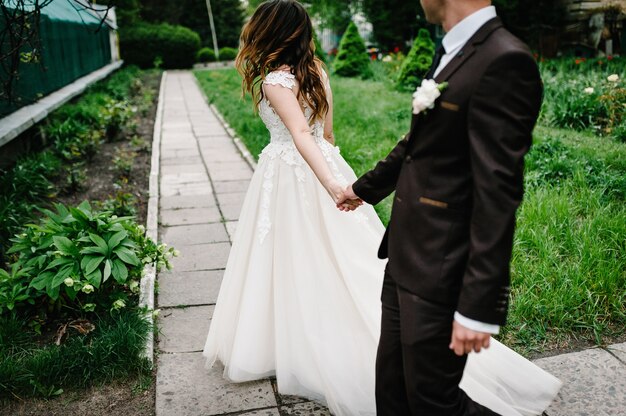 Attractive couple newlyweds back on track in the garden.