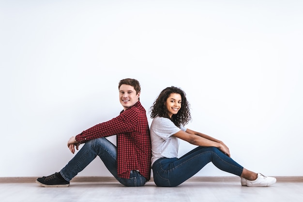 The attractive couple sitting on the floor