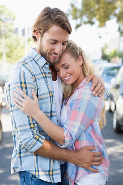 Attractive couple standing and hugging