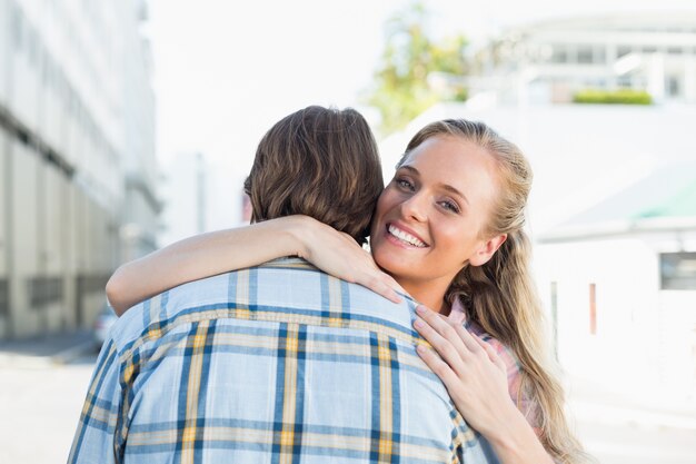 Attractive couple standing and hugging