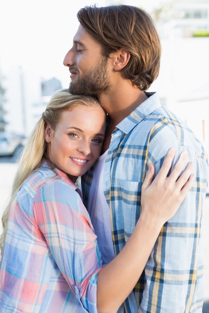 Attractive couple standing and hugging