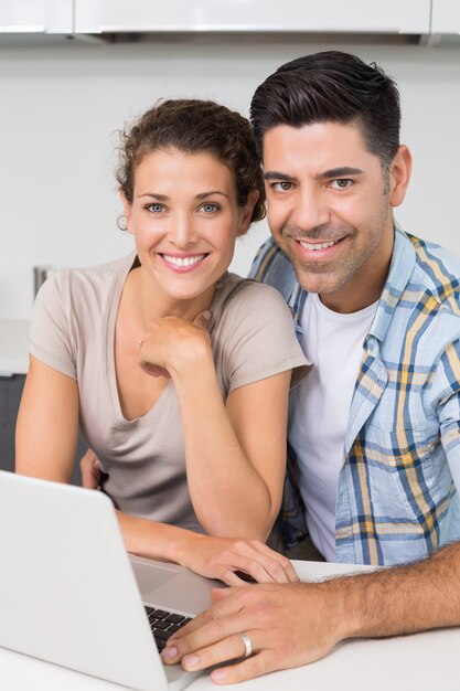 Attractive couple using laptop together