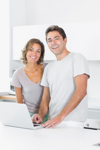 Attractive couple using laptop