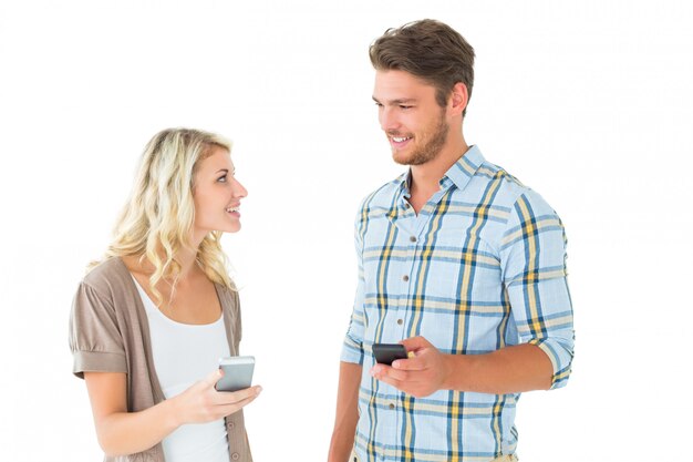 Attractive couple using their smartphones