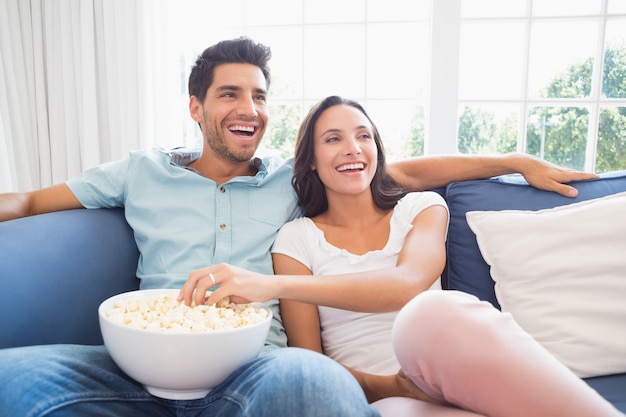 Attractive couple watching tv on the couch