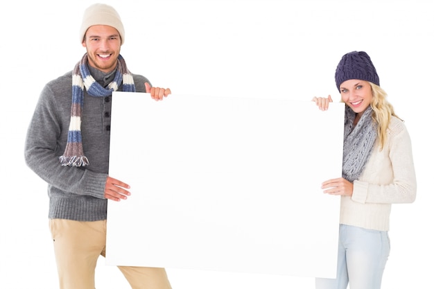 Attractive couple in winter fashion showing poster