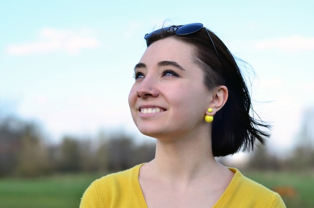 Attractive and cute Brunette girl in a yellow sweater 