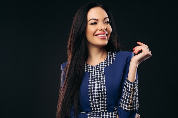 Attractive dark haired woman in office suit.