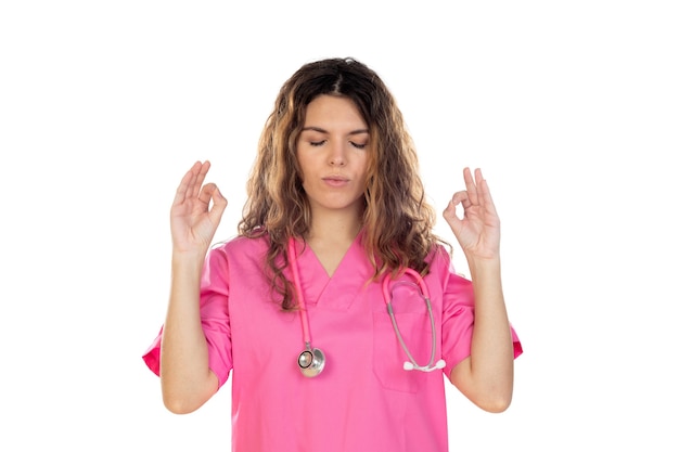 Attractive doctor wearing a pink uniform isolated on a white background