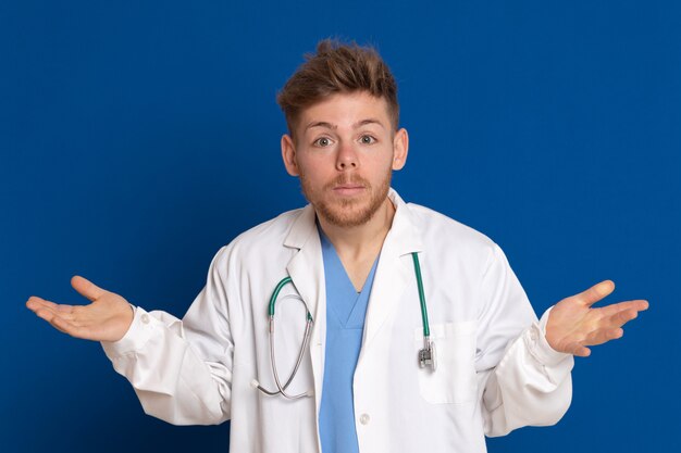 Attractive doctor with white lab coat on a blue